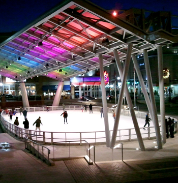 People ice skating in a rink.