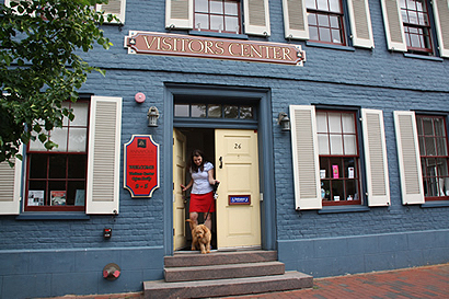 A visitor to a visitor's center with her dog.