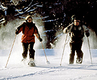 Man and woman snowshoeing together