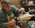 Gentleman carving a wooden duck decoy